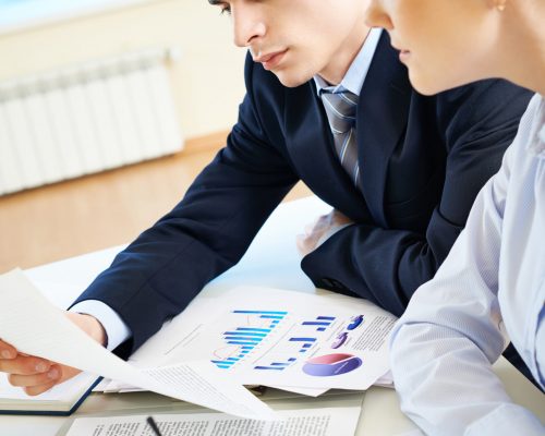 Business partners looking through papers at meeting